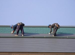 2 people doing a roofing job